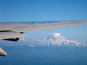 Mount Rainier is seen under the right wing of Air Force One while heading towards Seattle in Washington, July 24, 2012.  REUTERS/Larry Downing