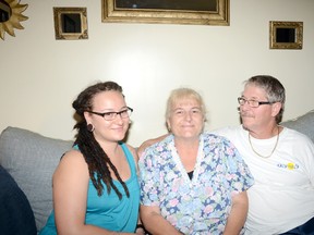 Mahoganie Hines, left, with her mother Denise and father Dave, in the family's home in Belleville. Denise suffered a heart attack earlier in August and credits her daughter's Loyalist College nursing skills in saving her life.