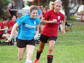 Julie Kerr of the Physiotherapy & Sports Injury Clinic team, dribbles the ball ahead of Screen Art's Allison Berkvens, during the final game of the Wallaceburg women's recreational soccer league on Thursday at Steinhoff Park. Physiotherapy & Sports Injury Clinic won the game 4-1 to win the league championship.