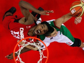 Canada's Tristan Thompson (left) attempts to go for a basket against Mexico's Roman Martinez during their FIBA Americas Championship. (REUTERS/Carlos Garcia Rawlins)