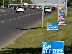 Traffic rolls by a row of these election signs along 170 Street, just south of West Edmonton Mall Thursday, Sept. 5. TOM BRAID/EDMONTON SUN PHOTO