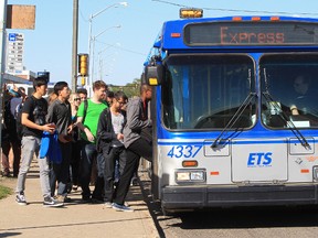 Northern Alberta Institute of Technology (NAIT) students board an Edmonton transit bus along 106 Street near Princess Elizabeth Ave., at the NAIT main campus, in Edmonton, Alta., Thursday Sept. 5, 2013. David Bloom/Edmonton Sun/QMI Agency