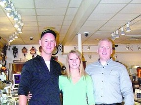 Andrew Cantin and Julie McNab, shown with James Poag, inside James O. Poag Jewellers in Strathroy, shortly after Andrew popped the question at the grocery store where the couple first met nearly five years earlier.