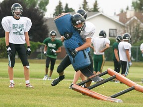 A member of the Panthers puts the hurt on a tackling sled during a practice. - Gord Montgomery, Reporter/Examiner