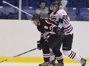 Sarnia Legionnaires defenceman Thomas Moxley battles Lambton Shores' Dillon Liberty for the puck during the Legionnaires home opener on Thursday, Sept. 5. The Legionnaires would go on to win the game 7-4. SHAUN BISSON/THE OBSERVER/ QMI AGENCY