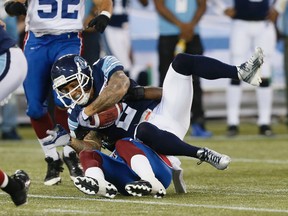 Chad Owens is brought down in Toronto's loss to Montreal on Tuesday night. (Stan Behal/Toronto Sun)