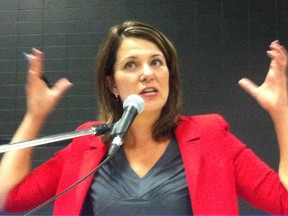 Wild Rose leader Danielle Smith gestures in High River, AB as residents address frustration, during a town hall meeting September 5, 2013 in High River AB, over the RCMP property damage and gun seizure during the June/July 2013 flooding. Edward Dawson/Sun TV/QMI Agency