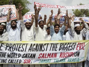 Members of the Islamic group Jamiat Talaba-e-Arabia march in 2007 to protest the awarding of a knighthood to British author Salman Rushdie, whose novel The Satanic Verses led to a fatwa.