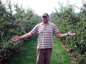 Joe Van de Gevel stands between rows of apple trees in his orchard at Great Lakes Farms near Port Stanley, one of the stops on Saturday's Elgin Farm Adventure Tour.