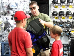 John Cannon of Point Edward makes a point to look for deals when buying hockey equipment for his sons Jay and Alex. (SHAUN BISSON, The Observer)