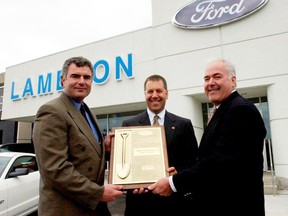 Lambton Ford president Harold Hall, right, is marking 50 years with the Sarnia dealership Monday. He's pictured here with Lambton Ford VP Rob Ravensburg, left, and Ford Executive Vice President Joe Hinrichs, receiving a Gold Shovel Award — recognizing customer satisfaction and ownership loyalty — after a dealership renovation in 2005. (Submitted photo)