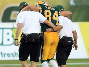 Cary Koch is helped off the field by Eskimos trainers during the first half of their 22-12 loss to the Calgary Stampeders in the Labour Day rematch at Commonwealth Stadium in Edmonton on Friday, Sept. 6. David Bloom/Edmonton Sun/QMI Agency