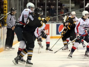 Josh Chapman of the Sarnia Sting puts a hit on Windsor's Chris Cobham in the second period of their game on Saturday, Sept. 7. The Sting would win the game 6-2.
SHAUN BISSON/THE OBSERVER/QMI AGENCY