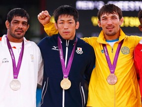 (L to R) India's Sushil Kumar, Japan's Tatsuhiro Yonemitsu. Kazakhstan's Akzhurek Tanatarov and Cuba's Livan Lopez Azcuy pose at the podium of the Men's 66Kg Freestyle wrestling at the ExCel venue during the London 2012 Olympic Games August 12, 2012.  (REUTERS)