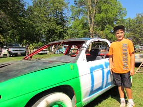 12-year-old Tyler Churchill tore the insides out of "Monster," and got it all ready to be demolished.  The car is one of 40 that competed at this year's demolition derby at Petrolia's fall fair. (MELANIE ANDERSON, The Observer)