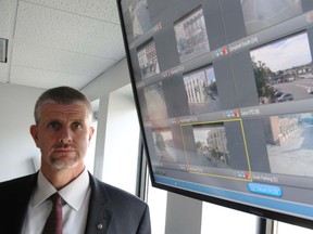 Deputy Chief Paul Vandegraaf stands next to the monitor displaying the views from cameras located in Belleville's core. The cameras are monitored in the police service's communication room.