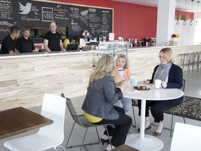 Friends enjoy coffee and snacks Monday at Edgar and Joe’s Cafe in the Goodwill building on Horton St. near Wellington St. The cafe serves develops workers for the food and hospitality industry. (Postmedia Network file photo)