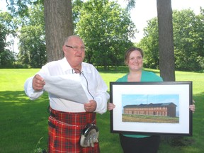 Dave Phillips, left, Elgin county's official town crier, placed 15rh at the World Invitational Town Crier competition in Kingston recently. With him is Angela Bobier of the Backus-Page House Museum.