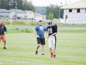 Whitecourt Cats head coach Kevin Babiuk takes some time after a play to give some advice to Connor Adams during a controlled scrimmage against the Athabasca Pacers on Aug. 29 at Graham Acres Sports Fields.
Barry Kerton | Whitecourt Star