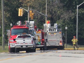 Emergency crews respond to a diesel fuel leak from a Sun Canadian pipeline Tuesday around noon. Crews are pictured here, beyond a road block at Tashmoo Avenue, in the area of Churchill Road and Vidal Street. (PAUL MORDEN, The Observer)