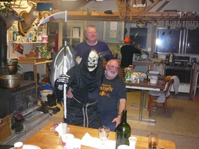 Jack Lake and the Grim Reaper sit at the kitchen table at the Mitten Lake Hunting Camp, on a Sunday night a few years ago, the day between Halloween and the opening of deer hunting season.