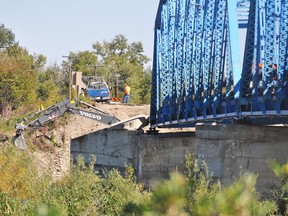 A Volker Stevin crew has started work by the bridge on Highway 547, which needs major repairs following the June 20 flood. Stephen Tipper Vulcan Advocate