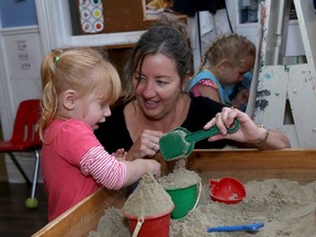 Destiny Frazer, 2 1/2 and director Sue Collins-Nixon play together in the sandbox during the first day of school at the Helen Tufts Nursery School in Kingston on Sept. 10.  
IAN MACALPINE/KINGSTON WHIG-STANDARD/QMI AGENCY