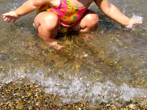 One-year-old Ava Harris plays in the waves at Canatara Park Beach during a record-breaking hot day. (The Observer file photo)