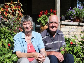 Margaret and Dick DeJong sit on their front step surrounded by the flowers in their garden on Wilson Street in Seaforth.