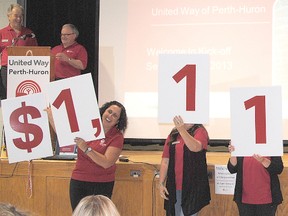 United Way representatives lift signs with large numbers to unveil the $1.115 million goal of the United Way of Perth-Huron 2013 campaign at the Sept. 6 launch and luncheon in Stratford. (Brian Shypula/QMI Agency)