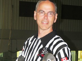 Gerry Gibbs, of Seaforth, winner of this year's Service to Sports award, poses at the Seaforth arena wearing his referee jersey while holding his announcer's mike and a disc of his favourite songs.