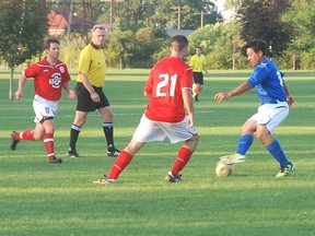 Lee Wilson, of the West Elgin Blue Devils, controls the ball against a Railway City FC defender Wednesday in the league final championship game at Miller Park in West Lorne. The Blue Devils won 3-1, for their eighth straight league championship, Watching the play on the right for West Elgin is Bradley Oliveira. (PATRICK BRENNAN, QMI Agency)
