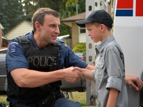 Eight-year-old Ethan Golvochenko was surprised by Make a Wish Foundation Sept.11, 2013 as he received a backyard play set and a special visit from London Police Services' chief Brad Duncan who came to meet Golvochenko along with the fellow police officers, ESR, the K9 Unit, London Police's Light Armoured Vehicle. SHOBHITA SHARMA/LONDONER/QMI AGENCY