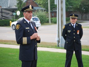 St. Thomas fire chief Rob Broadbent, left, speaks during a brief ceremony Wednesday that commemorated the anniversary of the Sept. 11, 2001 terrorist attacks in the United States. Members of the St. Thomas Police Service and paramedics gathered to remember those who lost their lives in the attacks, including emergency workers. Standing in back is Warren Scott, president of the St. Thomas Professional Fire Fighters Association. Ben Forrest/QMI Agency/Times-Journal