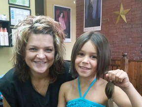 Eight-year-old Arawyn Kennedy of Tillsonburg (right) donated her hair to the Locks of Love program, which supports those battling cancer. Local hairdresser Jackie Ambo (left) of Jackie's Hair Studio in Tillsonburg was happy to do the honours for Kennedy. Contributed Photo