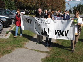 Members of Victims of Chemical Valley carry the group's banner in this file photo from last fall's Walk to Remember Victims of Asbestos in Sarnia's Centennial Park. The banner went missing this week from a fence in the park where it had been placed to serve as a backdrop at this year's walk and vigil, happening Saturday evening. PAUL MORDEN/ THE OBSERVER/ QMI AGENCY