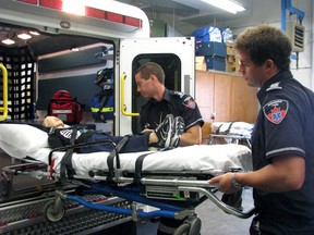 Second-year paramedic students Xander Silver (left) and Daniel Mott use the new ambulance installed at Lambton College for training. The vehicle lets students learn skills in confined spaces before entering emergency situations. MELANIE ANDERSON/THE OBSERVER/QMI AGENCY