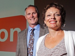 United Way of Quinte honorary chairman David Brown and executive director Judi Gilbert stand before a screen revealing their $2-million campaign total Thursday at Centennial Secondary School in Belleville, Ont. The charity must raise the amount by Dec. 31 in order to help fund about 75 programs at 43 local agencies. Luke Hendry/The Intelligencer/QMI Agency