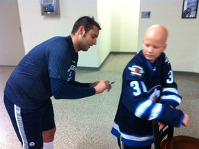 Jets goalie Ondrej Pavelec signs the No. 31 sweater of Justin Neudorf after a training camp scrimmage at the IcePlex on Thursday.