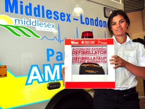 Brieanna Reilly, PAD and public education co-ordinator for Middlesex-London EMS, holds an automated external defibrillator at the Middlesex-London EMS Authority on Waterloo Street September 12, 2013.  CHRIS MONTANINI\LONDONER\QMI AGENCY