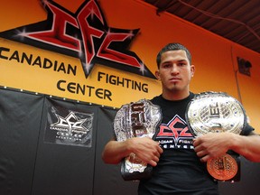 UFC lightweight champion Anthony Pettis holds his hardware at the Canadian Fighting Championship gym on Wardlaw Avenue. He's also holding the World Extreme Cagefighting lightweight belt. He was the champion when WEC merged with UFC. Pettis was in town to help publicize Friday night's CFC card at the Winnipeg Convention Centre. (KEVIN KING/Winnipeg Sun)