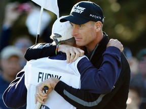 Jim Furyk (right) hugs his caddy after scoring a 59 during the second round of the BMW Championship in Lake Forest, Ill., Friday, Sept. 13, 2013. (Jim Young/Reuters)
