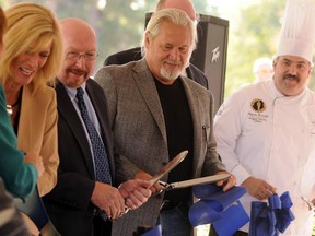 Developer John Wheeler, center, cuts the ribbon with other officials at the new DoubleTree Port Huron, Freighters restaurant and the Culinary Institute of Michigan.