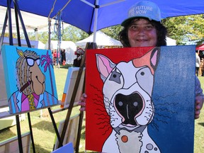 Wallaceburg artist Susa Botha Jacques shows off her acrylic animal paintings at Art in the Park in Bright's Grove Saturday. Like other vendors, Jacques reported being kept busy with requests for custom orders. BARBARA SIMPSON / THE OBSERVER / QMI AGENCY