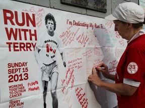 Valerie Taylor, of Sarnia, writes a message in honour of her parents at the Terry Fox Run held in Canatara Park Sunday, Sept. 15, 2013. The Sarnia woman, who has battled cancer twice herself, lost both her parents to the disease as well. (BARBARA SIMPSON, The Observer)