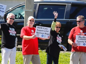 Protesters George Hewison, left, Doug McDonald, Margot Marshall and Paul Brown carry placards for passing drivers and pedestrians during a minimum wage protest on Saturday, Sept. 14, 2013 outside Tim Hortons at the intersection of Ashburnham Dr. and Lansdowne St.
Clifford Skarstedt/Peterborough Examiner/Postmedia Network file photo