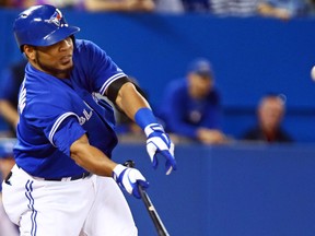 Edwin Encarnacion of the Toronto Blue Jays chips the ball to right field against the Baltimore Orioles at the Roger Centre on Sunday. (Dave Abel/Toronto Sun)