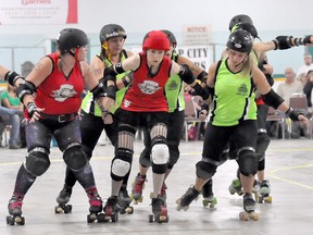 Headstone Honeys' jammer Kim Jong Wheels, third from left, had a challenging time pushing through Gang Green's defences during "The Final Boutdown" Saturday at the BDO Centre for the Community. Still, the Honeys performed much better against the Brandon team than they did in their first bout in May.