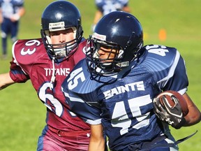 Tristan Kennelly of St. Theresa chases Quinte ballcarrier Anthony Aylesworth during Bay of Quinte junior football action Monday at QSS. (Paul Svoboda/The Intelligencer)