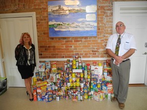 Kathy MacRae and Neil McCarney of the Gananoque Boat Lines pose with food collected for the town's food bank.  WAYNE LOWRIE Gananoque Reporter